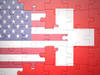 puzzle with the national flag of united states of america and switzerland.concept